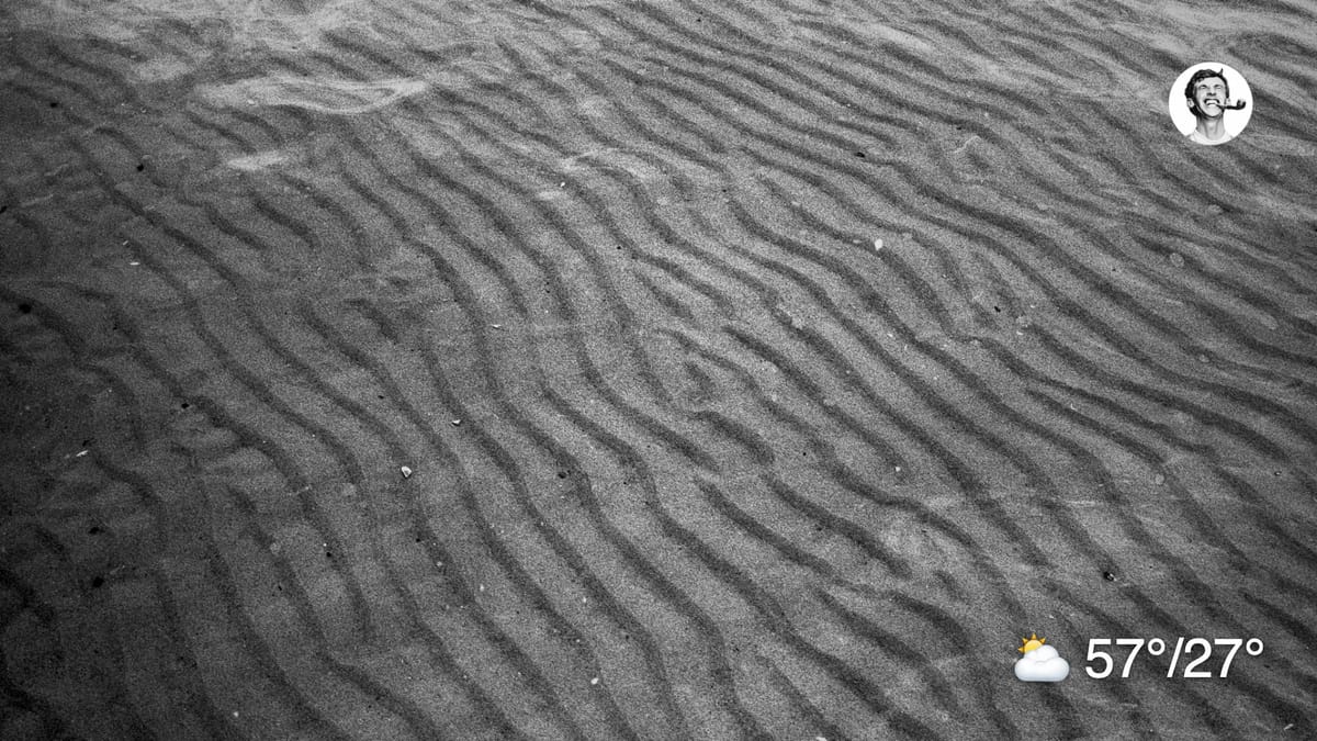 Black and white film photo of sand ripples under water